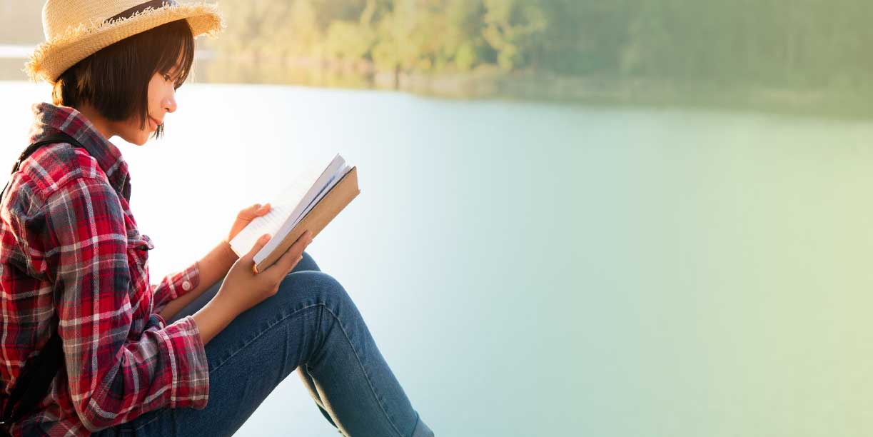 Asian Lady Reading Book by the Lake