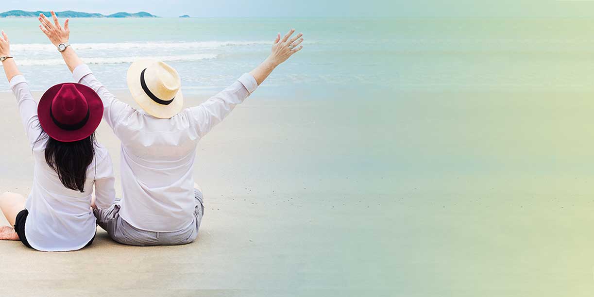Couple Setting at the Beach with Outstretched Armes