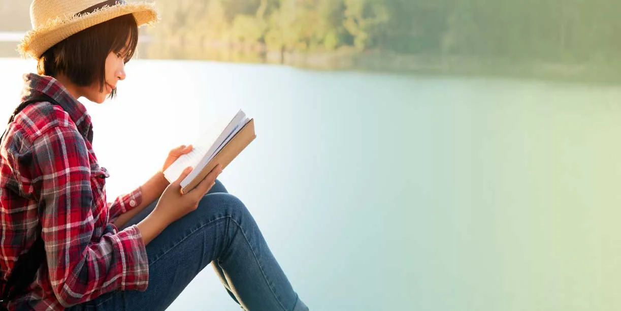 Asian Lady Reading Book by the Lake